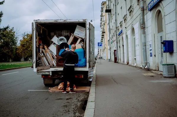 Junk removal — loading unwanted items into a truck